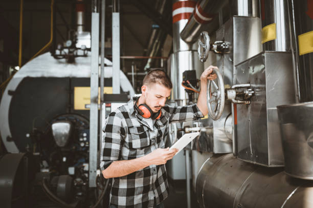 istock Young Technician is Inspecting Heating System in Boiler Room 1148894642