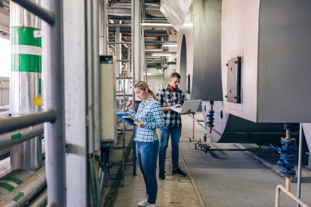 istock Young Technicians are Inspecting Heating System in Boiler Room 1148895373