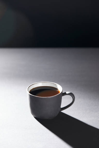 istock Cup of coffee on grey surface on black 1148895461