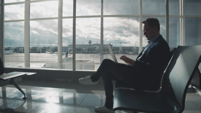 Entrepreneur using laptop while waiting at airport