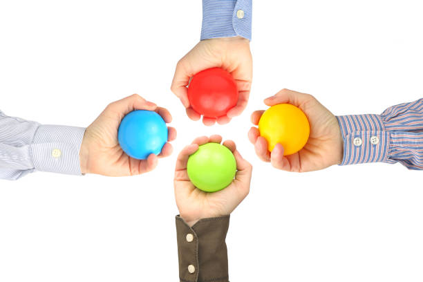 istock Men's hands with colorful plastic balls on white background 1148896505