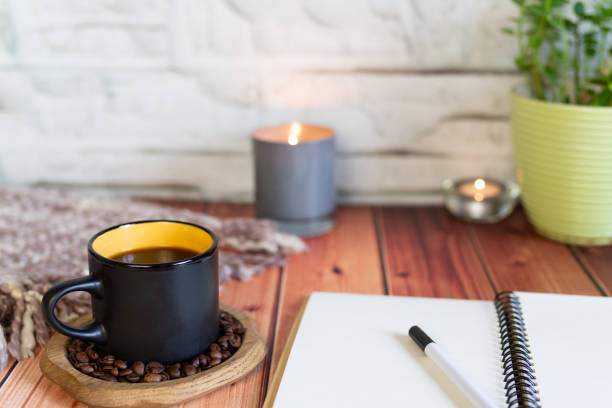 istock A Cup of coffee with notebook on a wooden table 1148896721