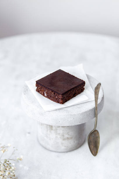 istock Vegan raw brownies with nuts and dates, on white marble background with copy space. Healthy dessert concept 1148897592