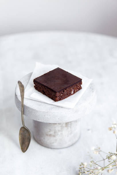 istock Vegan raw brownies with nuts and dates, on white marble background with copy space. Healthy dessert concept 1148897610