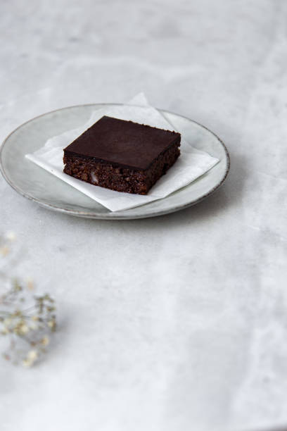 istock Vegan raw brownies with nuts and dates, on white marble background with copy space. Healthy dessert concept 1148897758