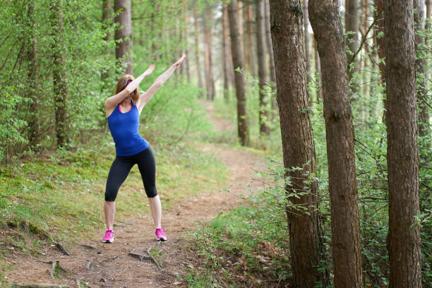 istock Athletic young woman dabbing after run in spring forest 1148897880