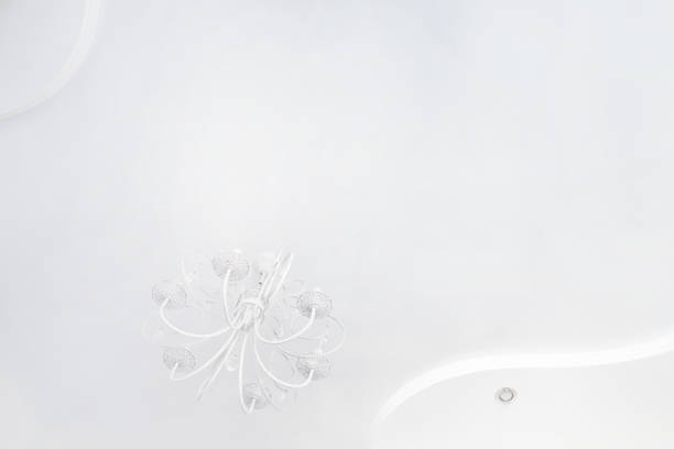 White stretch ceiling and beautiful classical chandelier