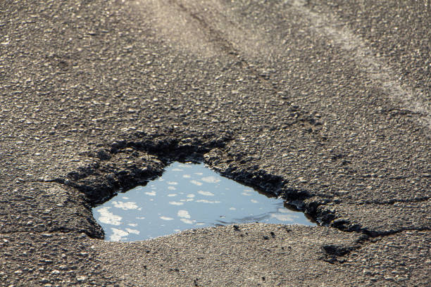 istock there are many potholes on the roadway close up 1148898382