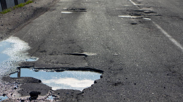 istock there are many potholes on the roadway close up 1148898393