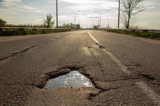 istock there are many potholes on the roadway close up 1148898399