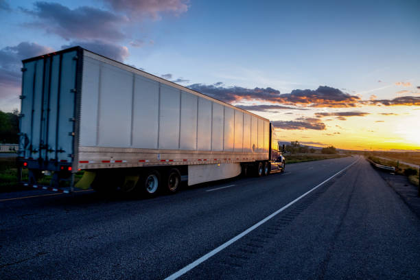 istock Long Haul Semi Truck on a Highway at Dusk under a Dramatic Sky 1148899649