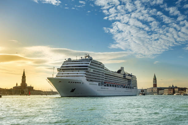 canal grande, big cruise ship at sunset in venice, italy stock photo