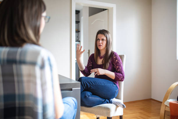 istock Deaf women talking in hand signs at home 1148903128