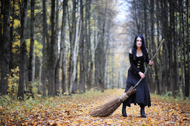 istock A woman in a witch suit in a forest 1148903134