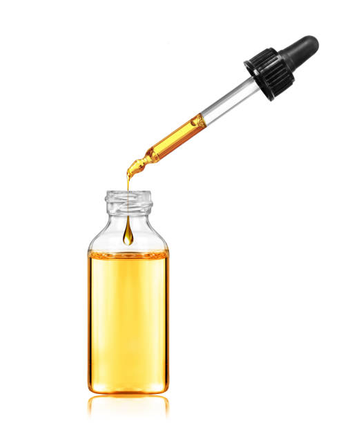 istock Drop drops from a pipette in a cosmetic bottle, isolated on white background 1148903991