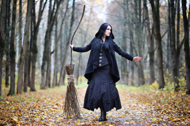 istock A woman in a witch suit in a forest 1148904534