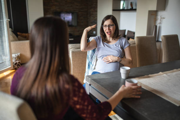 istock Beautiful deaf women enjoying coffee while talking with hand signs 1148906056