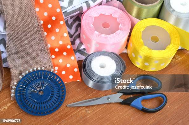 Color Ribbons Scissors And Pins Set On Wooden Plank Stock Photo - Download Image Now