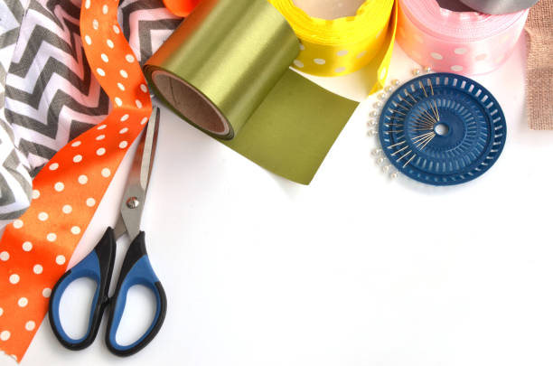 istock Flat lay made by color ribbons, scissors and pins on white background 1148906777