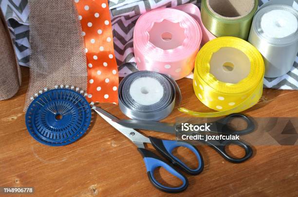 Color Ribbons Scissors And Pins Set On Wooden Plank Stock Photo - Download Image Now