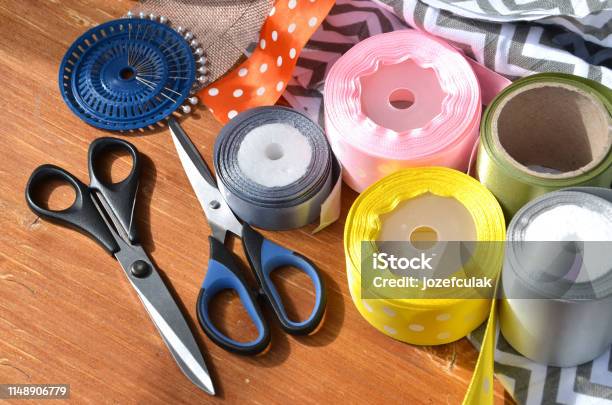 Color Ribbons Scissors And Pins Set On Wooden Plank Stock Photo - Download Image Now