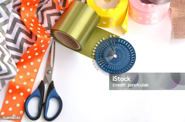 Flat Lay Made By Color Ribbons Scissors And Pins On White Background Stock Photo - Download Image Now