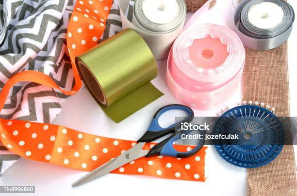 Flat Lay Made By Color Ribbons Scissors And Pins On White Background Stock Photo - Download Image Now
