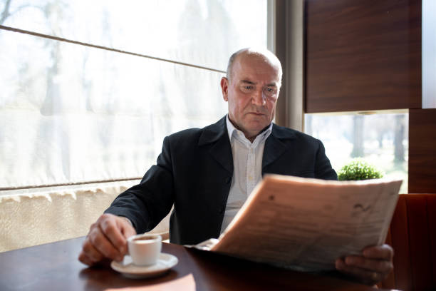 istock Serious and angry senior man reading newspapers 1148907517