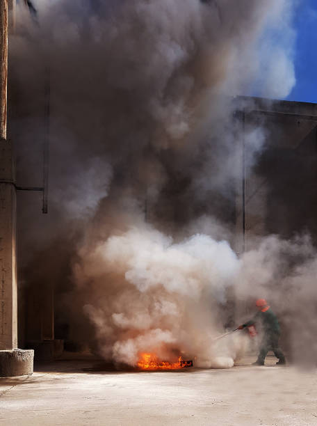 istock fireman extinguishes the fire with smoke. Firefighting exercises with fire extinguishing. 1148907751