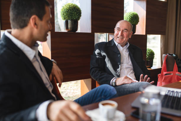istock Comfortable and cheerful businessmen spending leisure time at a cafe 1148908372