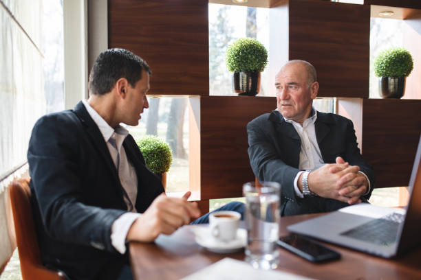istock Successful businessmen having a business discussion at a cafe 1148908947