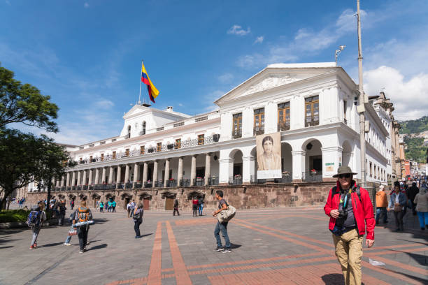 Quito, Ecuador - February 22, 2019: Tourists walking around the main square in old town Quito.