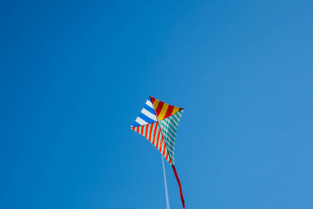 istock Colorful kite flying with waving red bow 1148910379