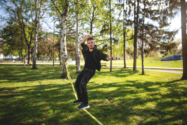 istock Acrobat balancing on a slackline at a park 1148910398