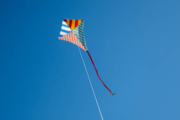 istock Colorful kite flying with waving red bow 1148910404
