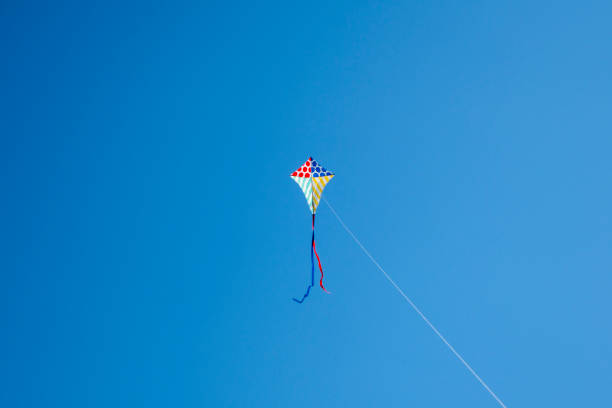 istock Colorful kite flying with waving red bow 1148910430