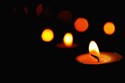 Candle light and light bokeh with  dark black background.