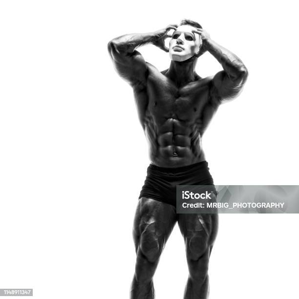 Mysterious Muscular Man Hiding Behind White Mask Bodybuilder With White Mask On His Face Studio Shot On White Background Stock Photo - Download Image Now