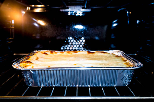istock Grated lasagne foil tray in oven 1148912947