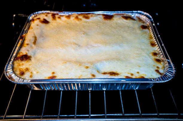 istock Grated lasagne foil tray in oven 1148912948
