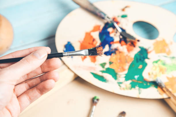 istock man hand brush with paint 1148914757