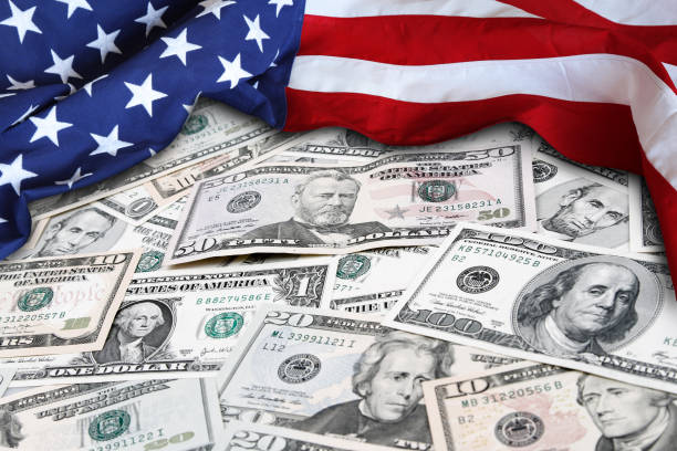 istock USA flag and cash 1148916857