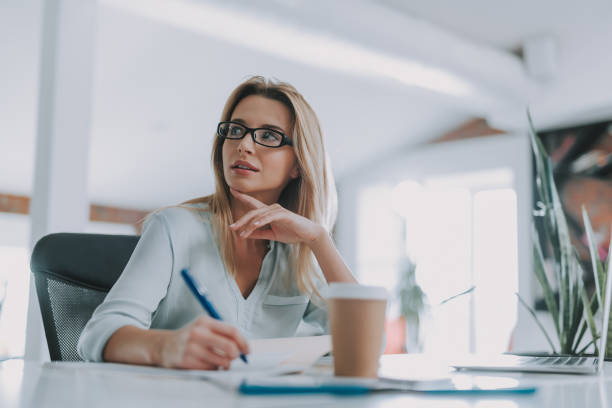 istock Thoughtful woman working at the table and looking away 1148917366
