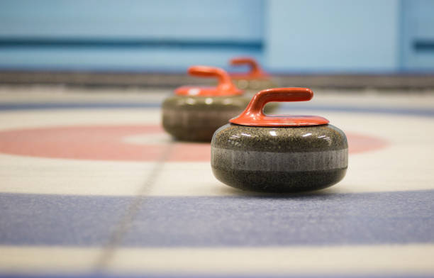 istock two granite curling rocks on the ice 1148918149