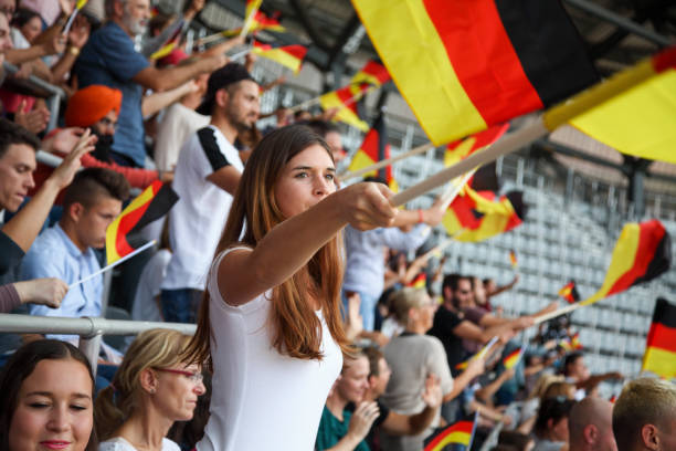 istock Young woman as spectator on a stadium with german flags 1148919569