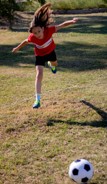istock Little girl playing soccer 1148920334