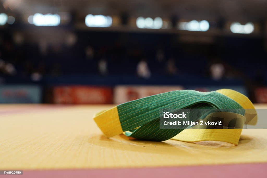 BJJ brazilian Jiujitsu competition green and yellow belt on the tatami mats at the tournament Brazilian Jiu-Jitsu Stock Photo