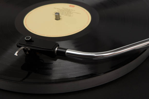 Turntable black playing vinyl close up with needle on the record.