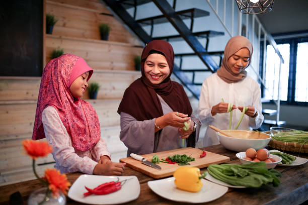 istock Mother and two daughter preparing food 1148922441