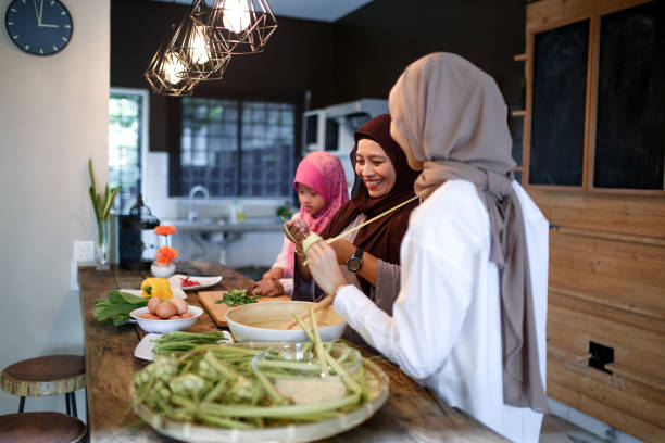 istock Mother and two daughter preparing food 1148922448